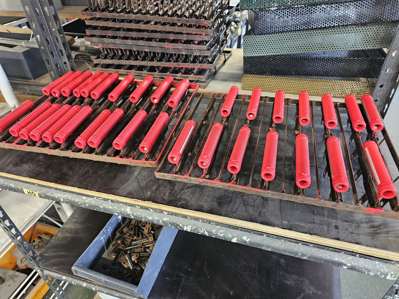 Red-coated wire wound resistors curing on production racks